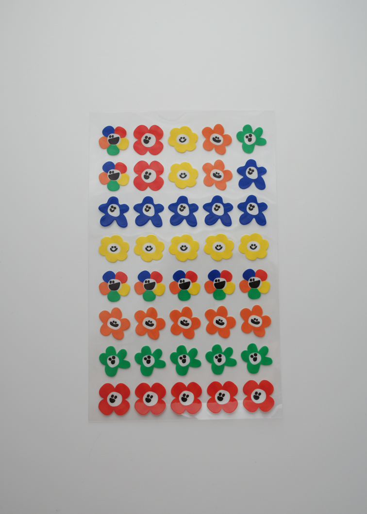 Colorful flower-shaped stickers on a white background
