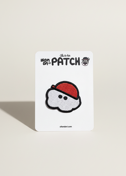 Card with an iron-on patch of a cloud with a red hat on a beige background