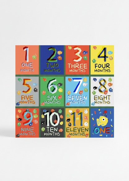 Baby milestone cards with colorful numbers, fishes, and months displayed on a white background