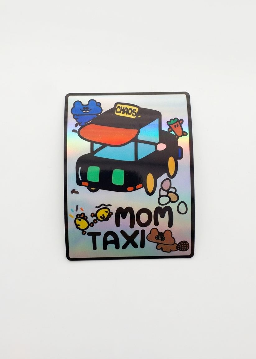 Holographic sticker with a cartoon taxi and 6 whimsical animals running around the car/taxi. 'Mom Taxi' text at the bottom.
